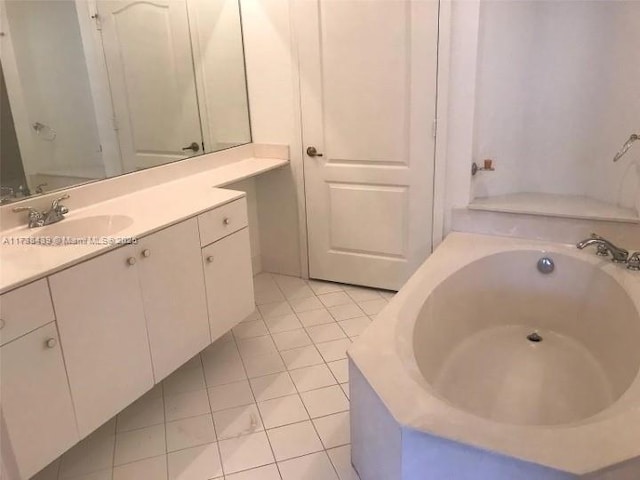 bathroom with tile patterned flooring, vanity, and a bathtub