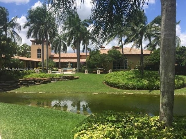 view of property's community featuring a water view and a lawn