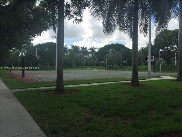 view of home's community with basketball court and a lawn