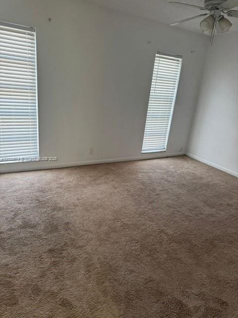 carpeted empty room with ceiling fan