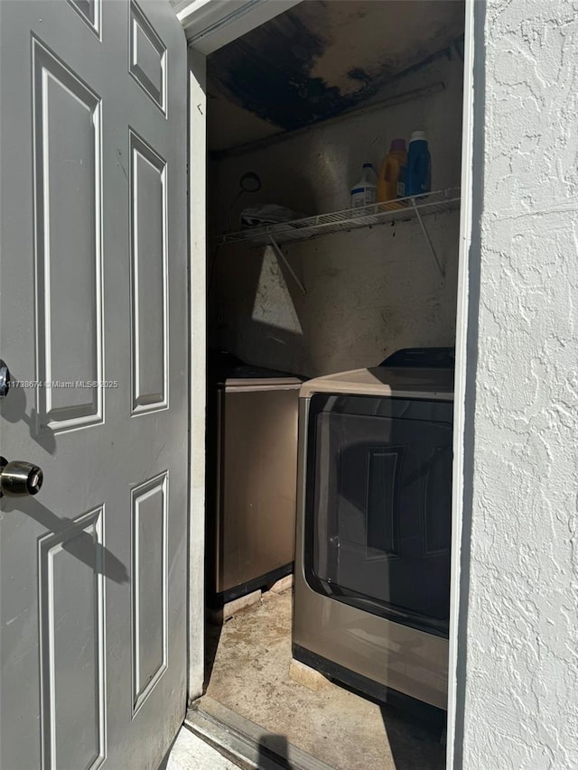 clothes washing area featuring washer / dryer