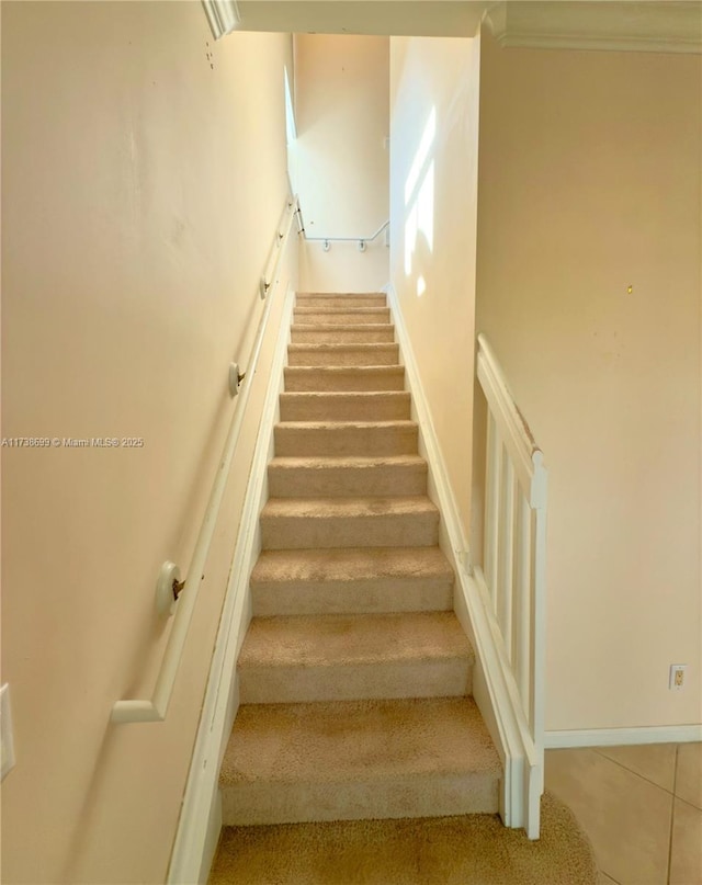 stairway with tile patterned flooring and baseboards