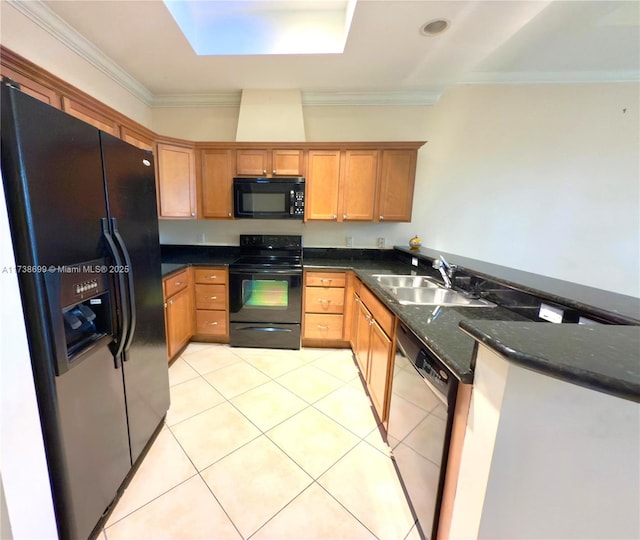 kitchen featuring dark stone countertops, light tile patterned floors, a sink, crown molding, and black appliances