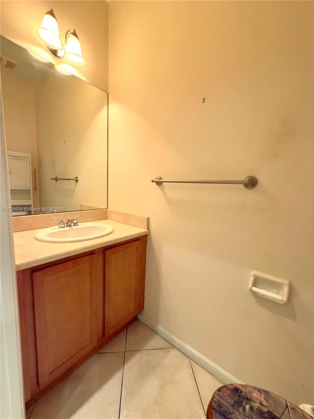 bathroom featuring tile patterned flooring, baseboards, and vanity