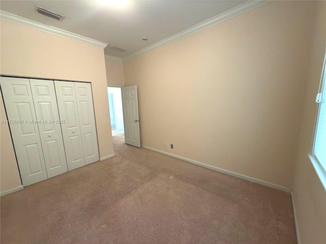 unfurnished bedroom with ornamental molding, visible vents, light carpet, and baseboards