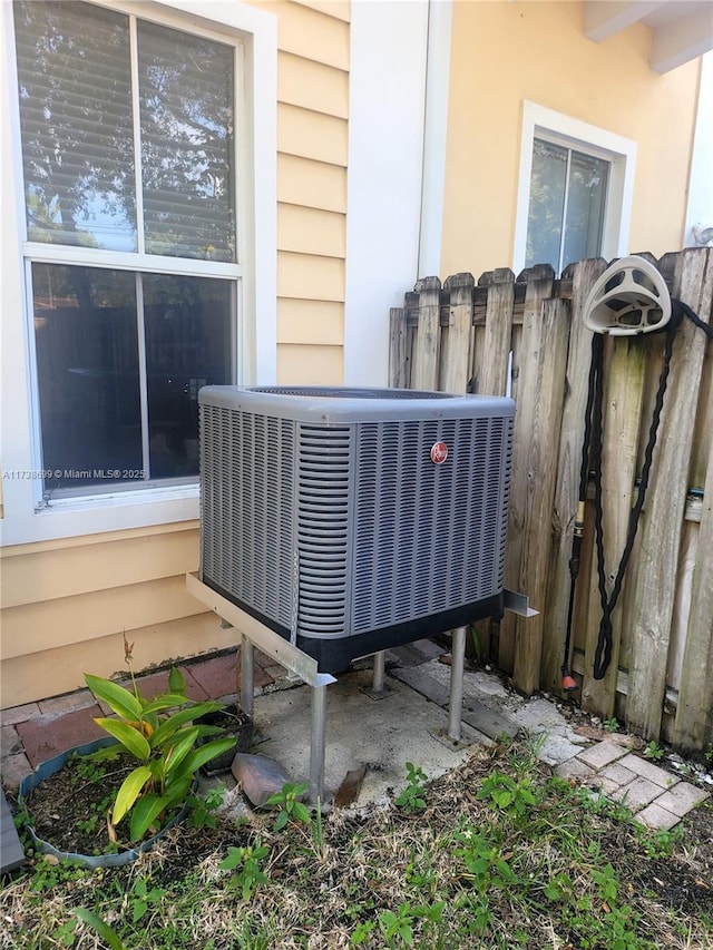 details featuring fence and cooling unit