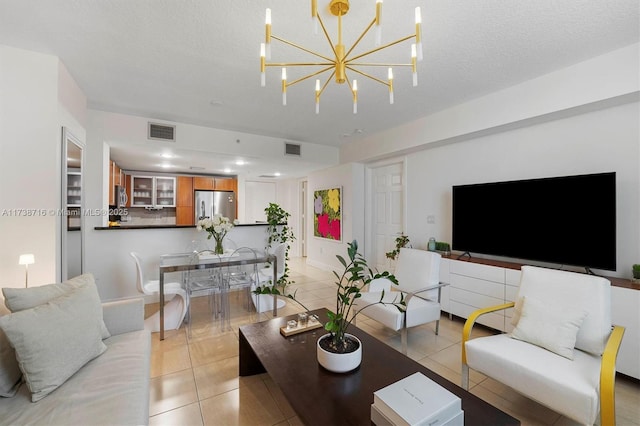 living room with light tile patterned floors and a textured ceiling