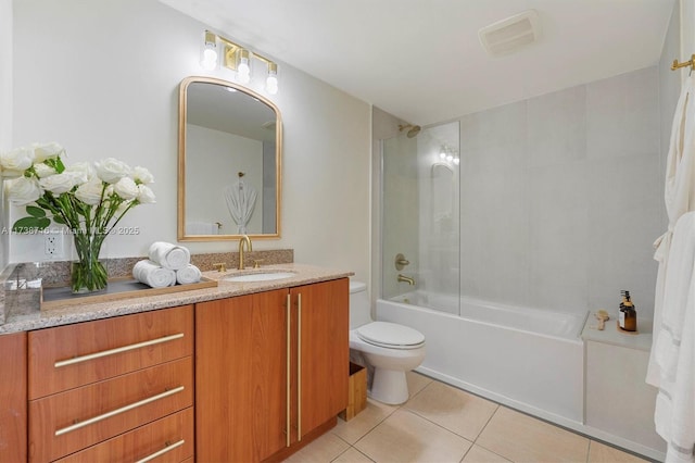 full bathroom with tile patterned floors, toilet, tiled shower / bath combo, and vanity