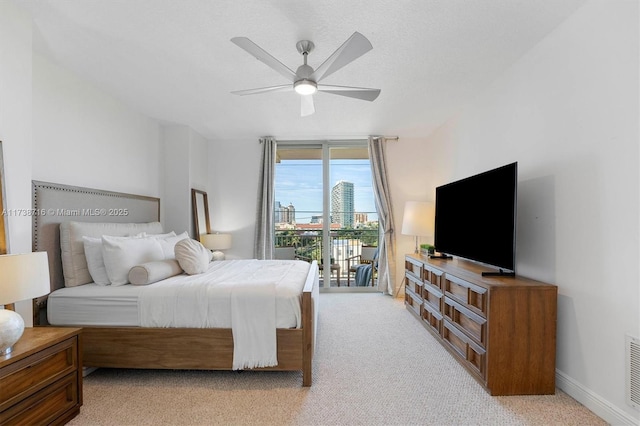 carpeted bedroom featuring floor to ceiling windows, access to exterior, and ceiling fan