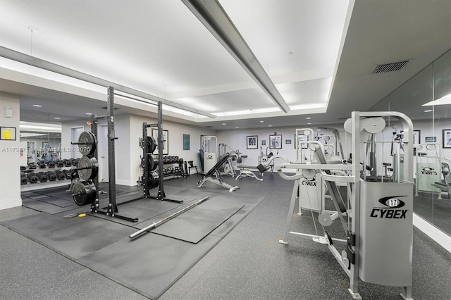 gym featuring a tray ceiling