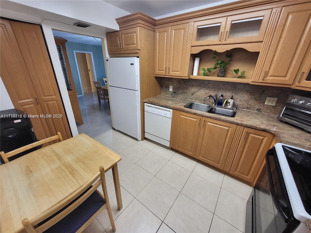 kitchen with tasteful backsplash, sink, white appliances, and dark stone countertops