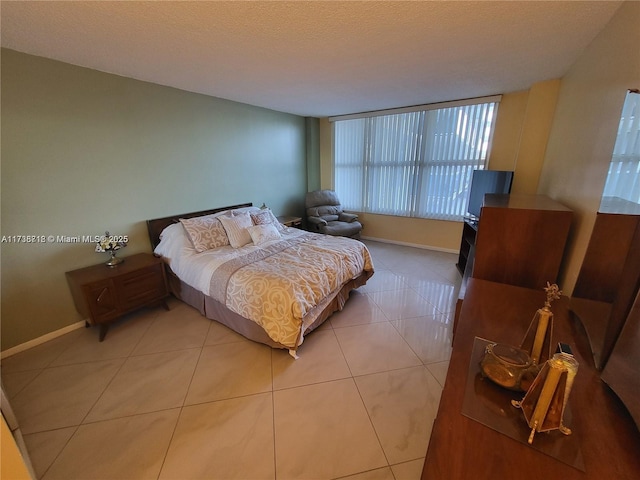 tiled bedroom featuring a textured ceiling