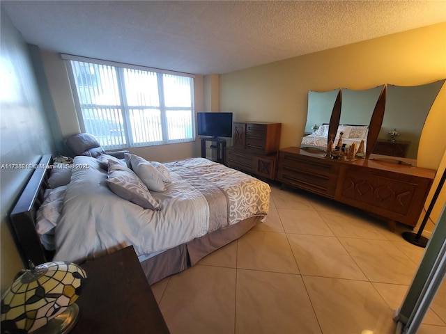 bedroom featuring a textured ceiling and light tile patterned floors