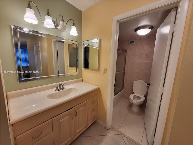 full bathroom with toilet, vanity, bath / shower combo with glass door, and tile patterned flooring