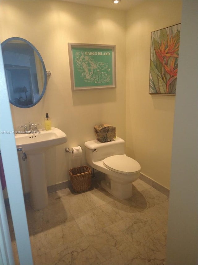 bathroom featuring sink and toilet