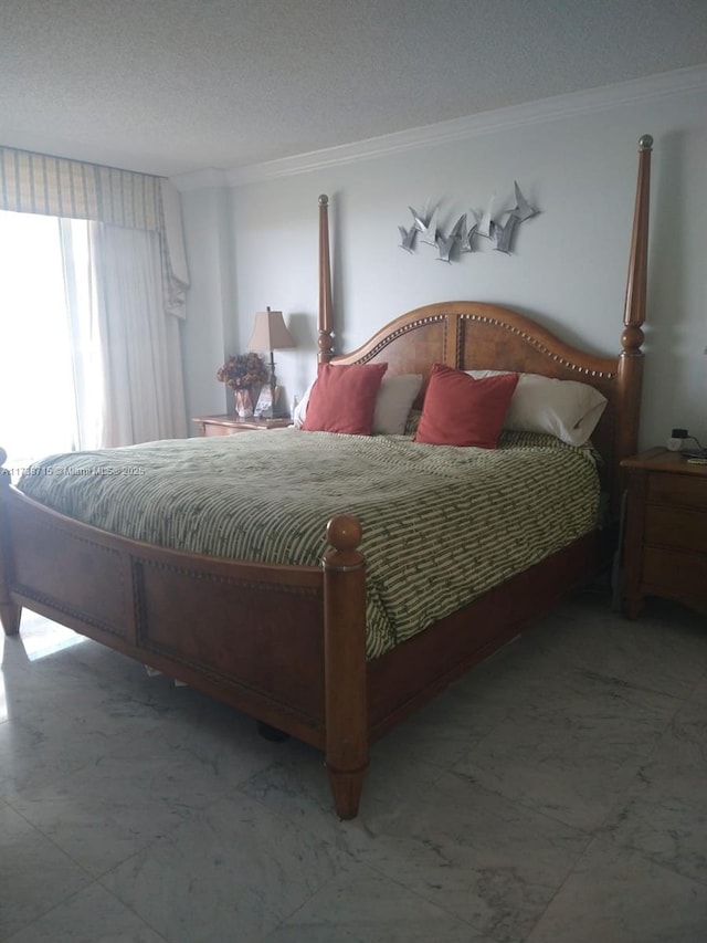 bedroom with ornamental molding and a textured ceiling