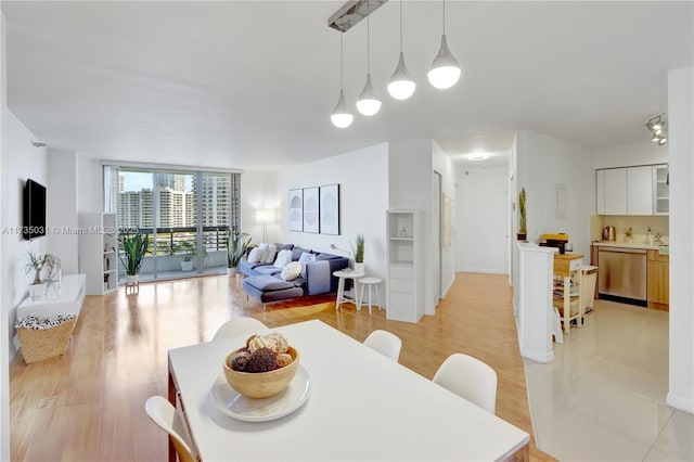 dining area featuring light hardwood / wood-style floors and floor to ceiling windows