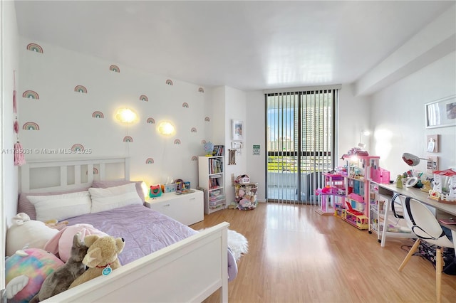 bedroom featuring access to exterior and light wood-type flooring