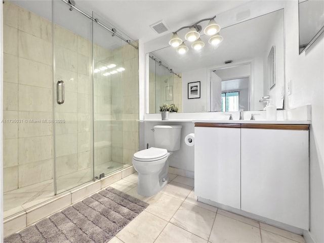 bathroom featuring a shower with door, vanity, tile patterned flooring, and toilet