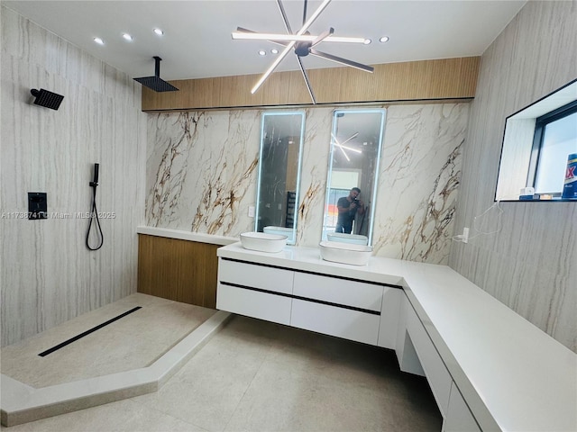 bathroom with walk in shower, plenty of natural light, vanity, and a notable chandelier