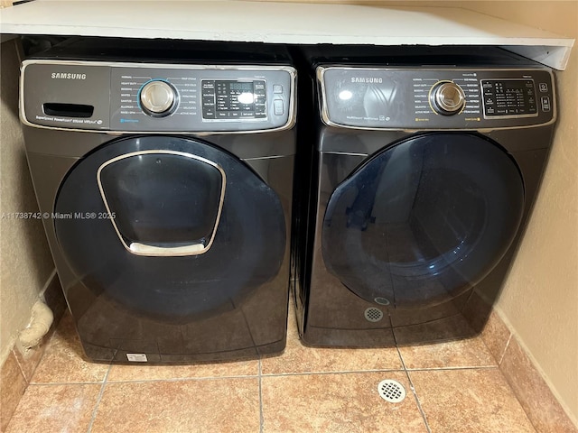 laundry room with tile patterned flooring and separate washer and dryer