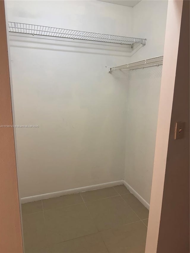 walk in closet featuring tile patterned floors