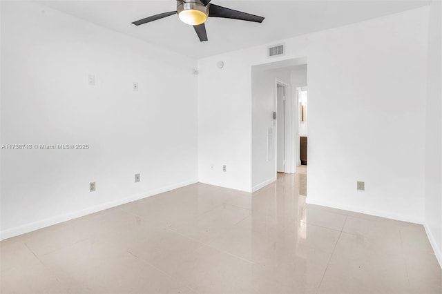 spare room with light tile patterned floors and ceiling fan