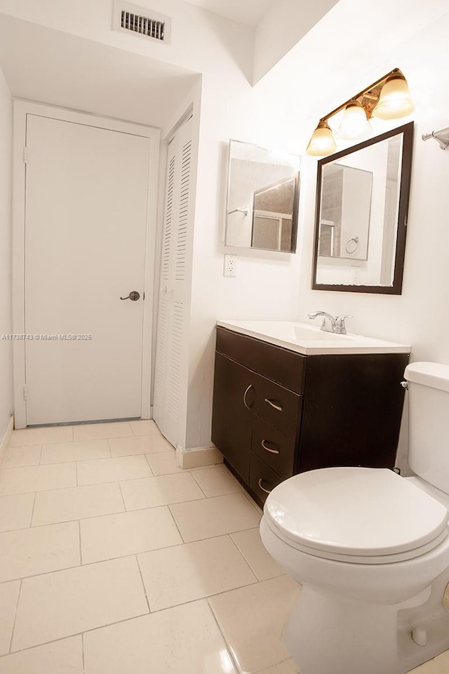 bathroom featuring toilet and vanity