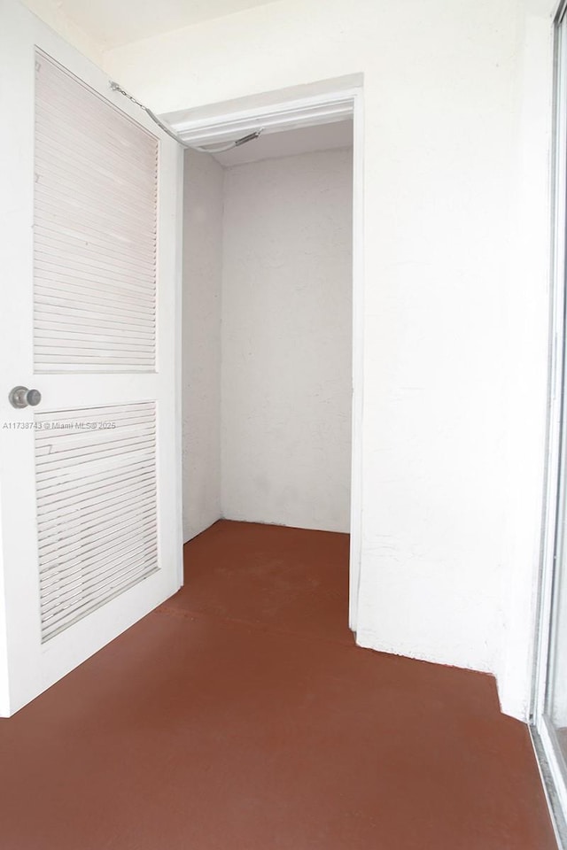 unfurnished room with concrete floors