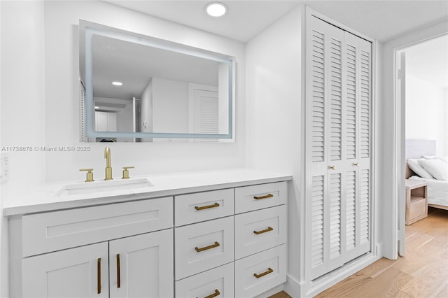 bathroom with hardwood / wood-style flooring and vanity