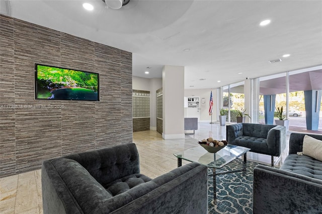 living room featuring tile walls and floor to ceiling windows