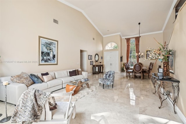 living room with crown molding and high vaulted ceiling