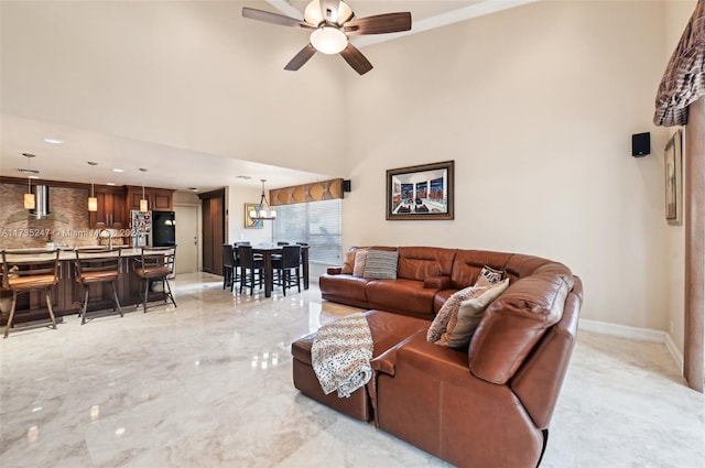 living room with sink, a towering ceiling, and ceiling fan