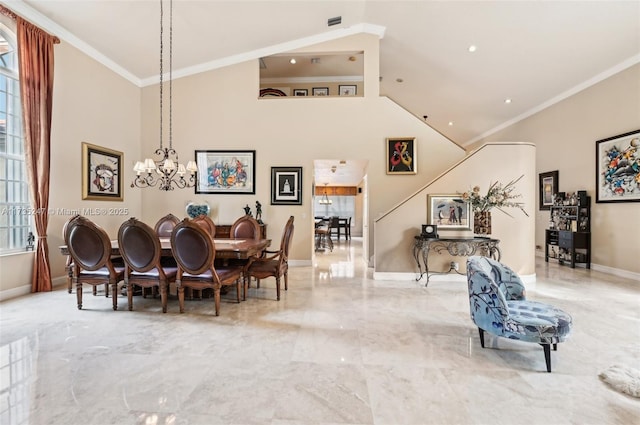 dining room with a notable chandelier, crown molding, and a high ceiling