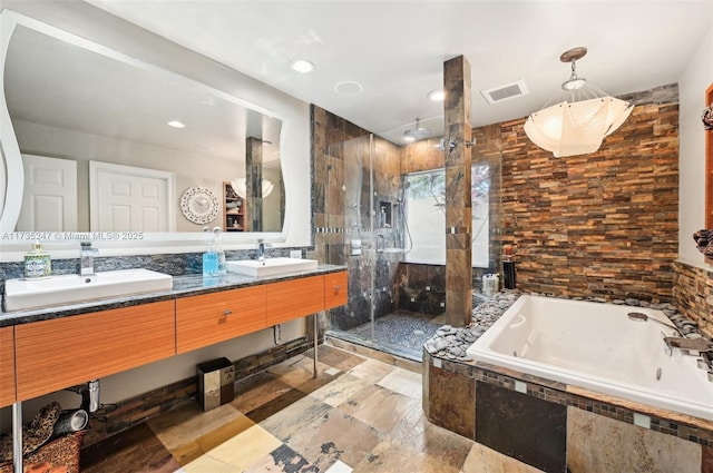 bathroom with vanity, plus walk in shower, and tile walls