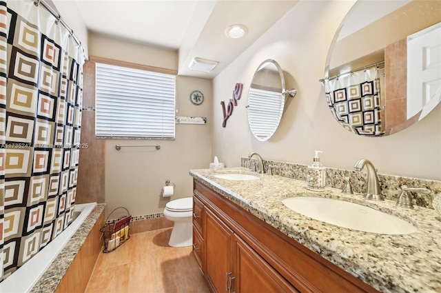 full bathroom featuring vanity, toilet, and shower / bath combo with shower curtain