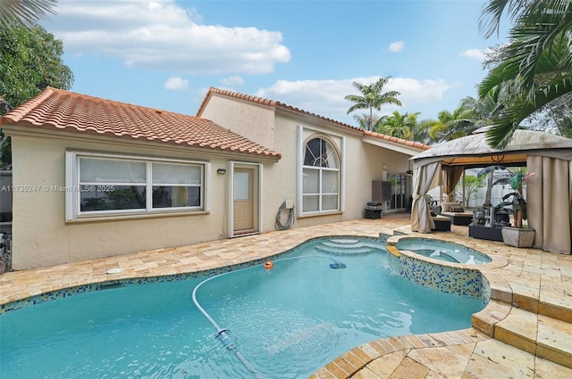 view of swimming pool featuring an outdoor living space, a gazebo, a patio area, and an in ground hot tub