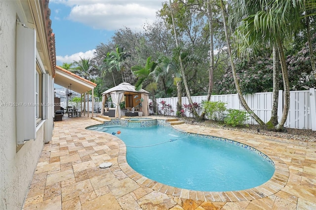 view of swimming pool featuring a gazebo, an in ground hot tub, and a patio area