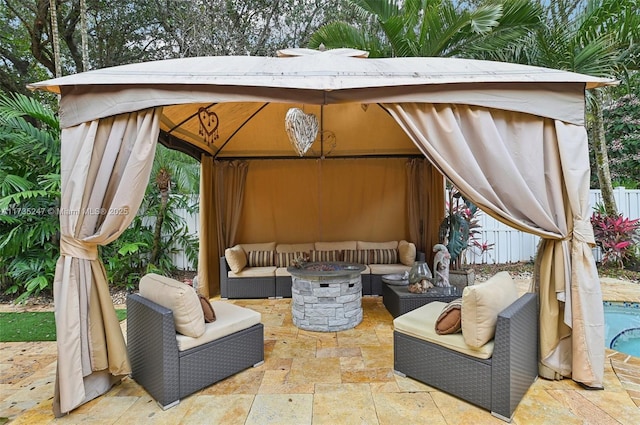 view of patio with a gazebo and an outdoor living space with a fire pit