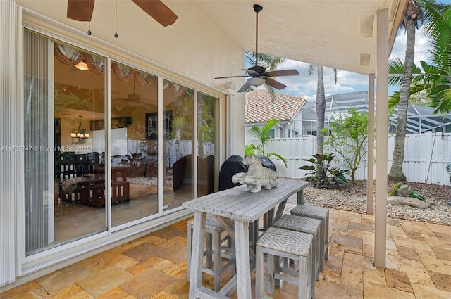 sunroom featuring ceiling fan