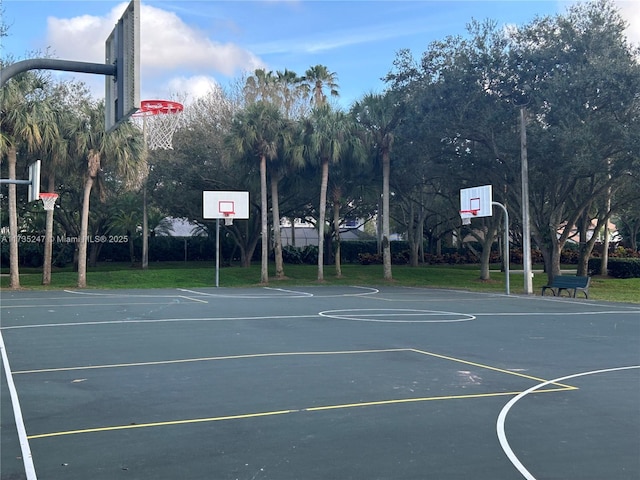 view of sport court with a yard