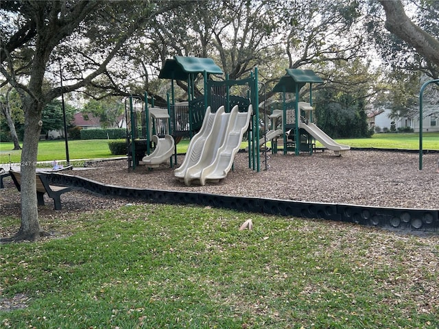 view of jungle gym featuring a lawn