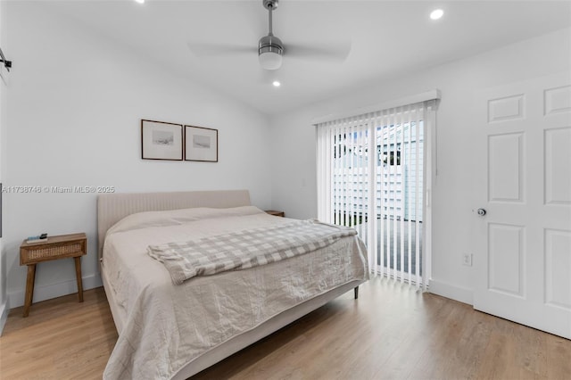 bedroom with access to outside, light hardwood / wood-style floors, ceiling fan, and vaulted ceiling