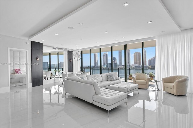 living room featuring floor to ceiling windows and a water view