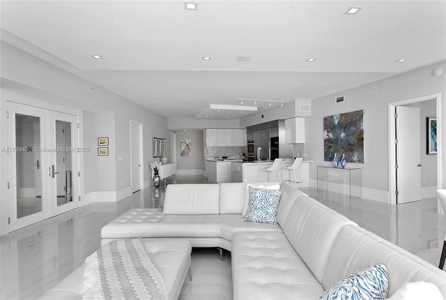 living room featuring baseboards, marble finish floor, french doors, and recessed lighting