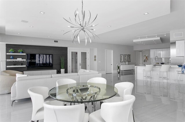 dining room featuring a notable chandelier and french doors