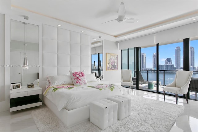 bedroom featuring access to exterior, a view of city, recessed lighting, ceiling fan, and refrigerator with ice dispenser