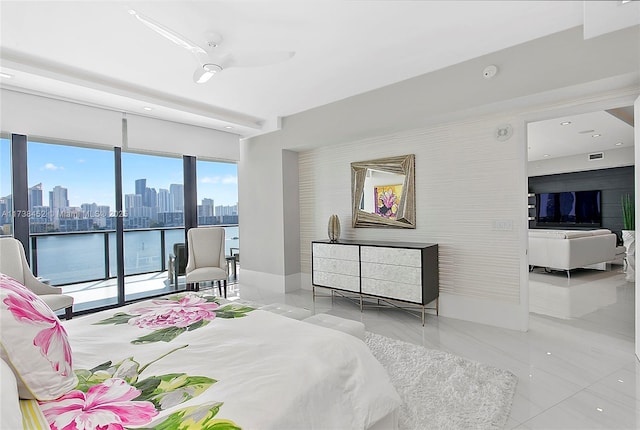 bedroom featuring baseboards, access to exterior, and a city view