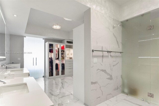 bathroom featuring walk in shower and vanity