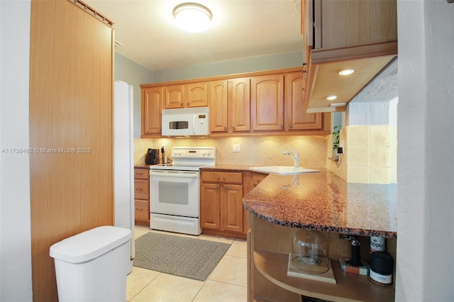 kitchen featuring sink, white appliances, tasteful backsplash, light stone counters, and light tile patterned flooring